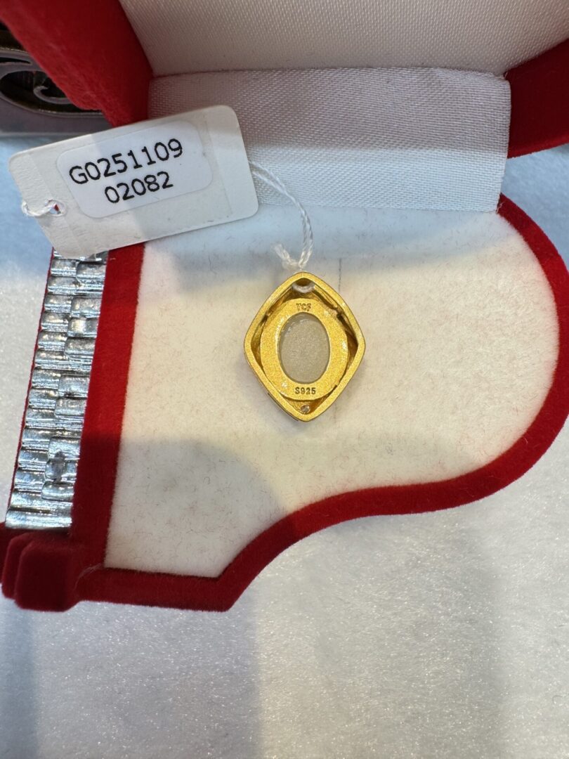 Gold oval-frame pendant stamped S925 in box