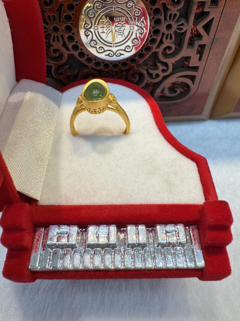Gold ring in red and white box.