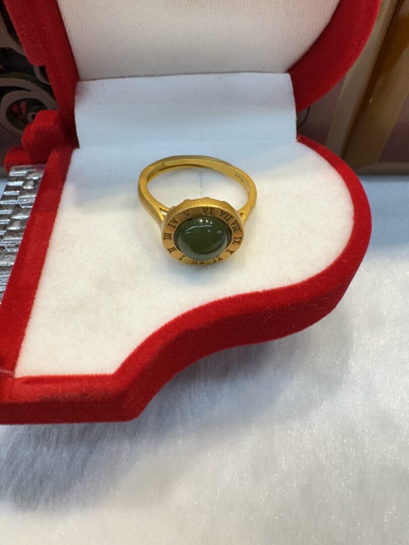 Gold jade cabochon ring in red velvet box
