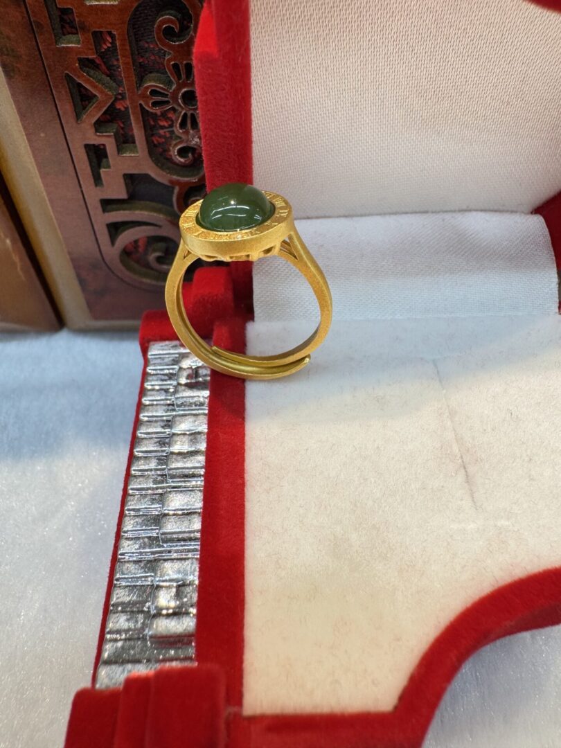 Side view of gold ring with green cabochon
