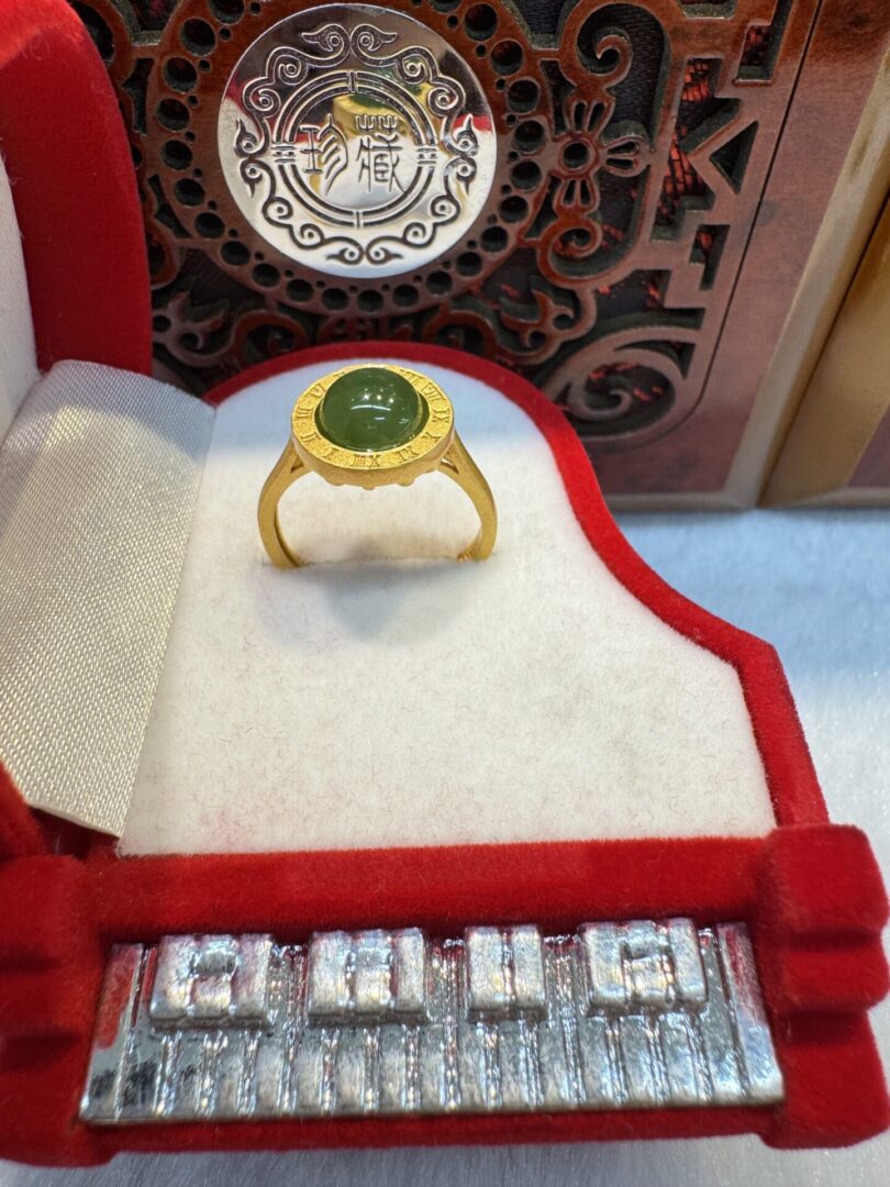 Gold ring centered in red velvet box