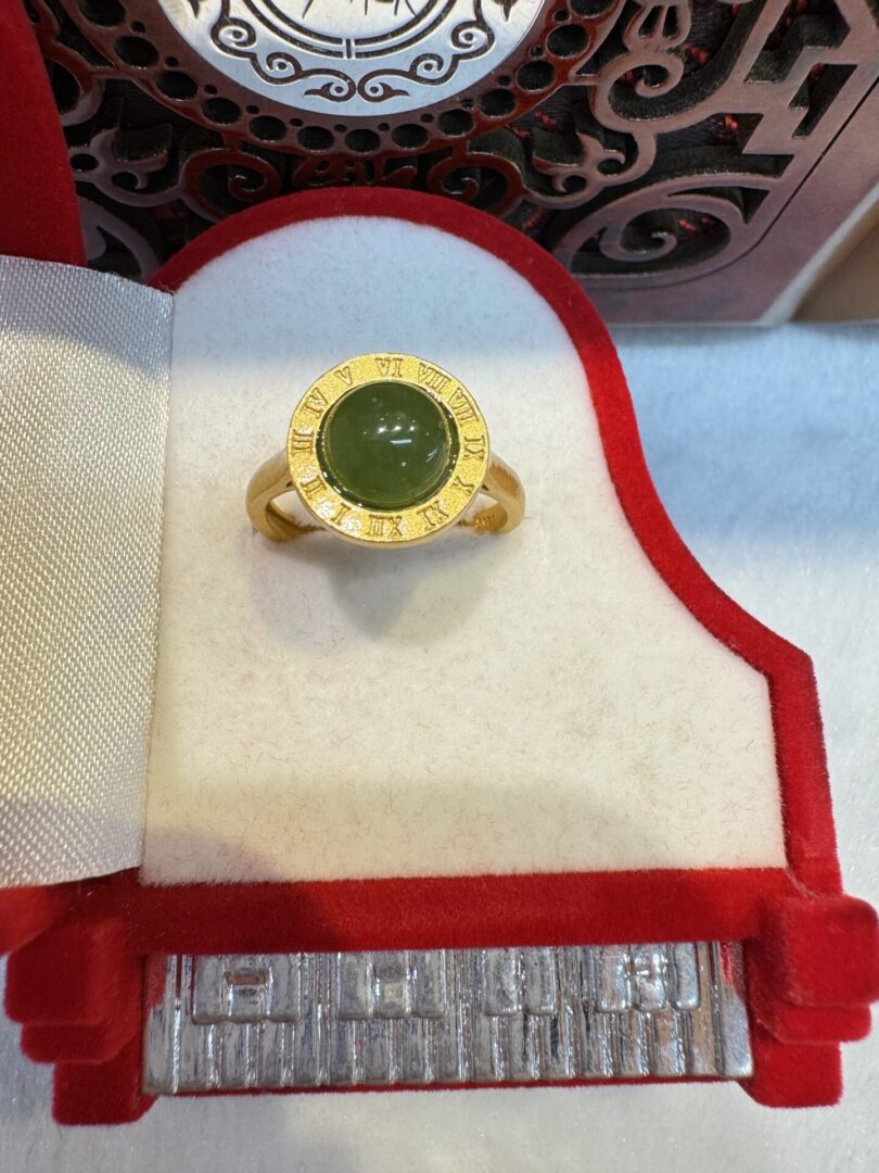 Ring with Roman numeral bezel and jade