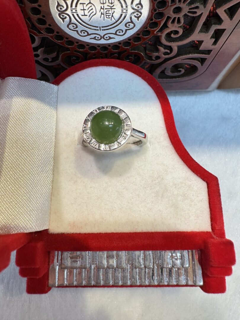Green cabochon ring displayed in red box