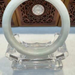 Round pale jade bangle with ornate background