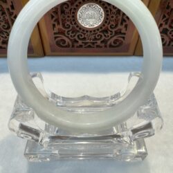 Close-up glossy jade circle on crystal holder