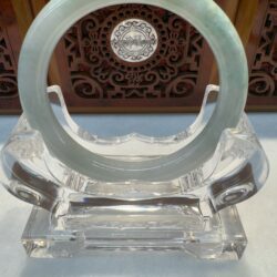 Green jade bangle on clear stand