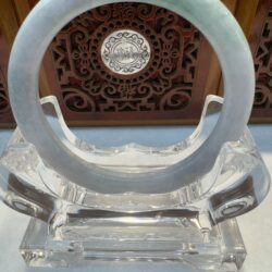 Translucent jade ring on clear crystal stand