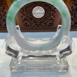 Light green jade ring on acrylic display
