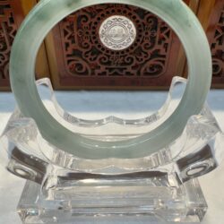 Jade bangle with darker veins on display
